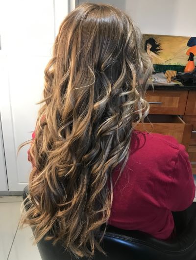 women's long curly hair blowdry highlights